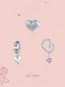 Detailed macro of S925 sterling silver heart charms and pink zircon pendants