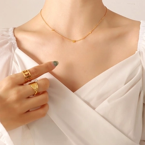 Minimalist 18K gold plated heart necklace and geometric ring set on female model
