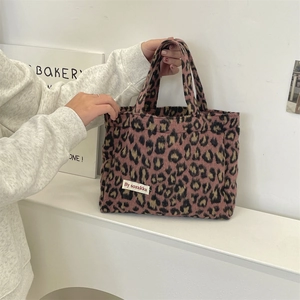 Close-up of pink leopard print tote bag with soft texture and brand logo label