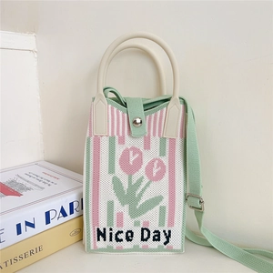 Close-up of knit tulip pattern and Nice Day text on the crossbody phone bag