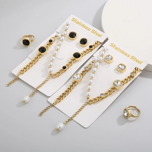 Detailed set of gold stainless steel jewelry featuring pearls and black zircon stones