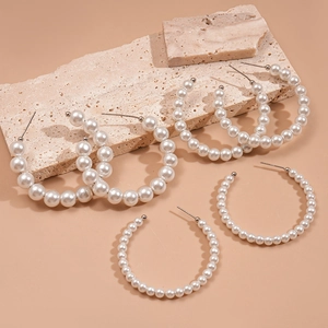 Three pairs of elegant C-shaped faux pearl hoop earrings in varying sizes for women