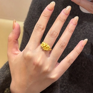 Elegant gold plated floral open ring featuring a matte finish blossom design on finger