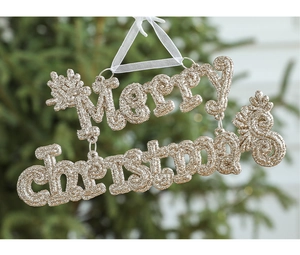 Macro detail of golden glitter Merry Christmas lettering hanging on a Christmas tree branch