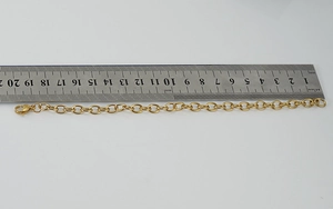 Detail view of 18.5cm gold stainless steel chain link with steel ruler measurement
