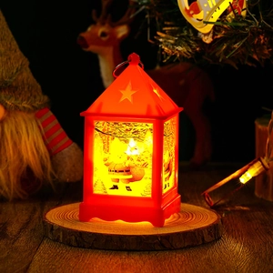 Detail of red Christmas LED lantern with Santa silhouette and warm glowing light