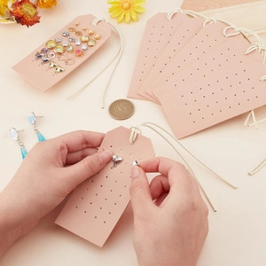 Pink PU leather earring display cards with hanging ropes and pre-punched holes