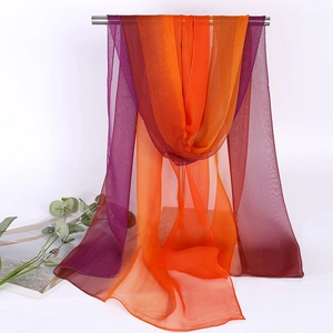 Detail of thin gradient chiffon scarf in purple and orange with semi-transparent texture