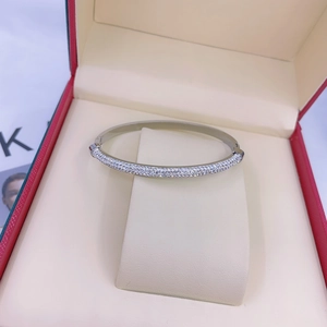 Macro shot of silver titanium steel bracelet with pavé diamonds in a red jewelry box