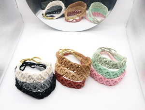 Detail of nine handmade macrame headbands in various colors with adjustable knots