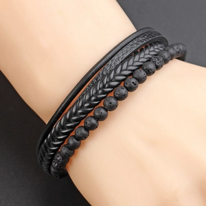 Macro detail of men's multilayer black leather cord and volcanic stone bead bracelet