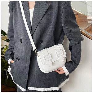 Detail of white PU leather saddle bag showing adjustable strap and buckle closure