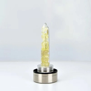 Detail view of crystal energy water bottle base with yellow citrine and stainless steel