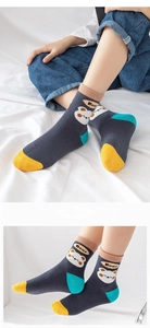 Close-up of knit cotton socks with cute bear pattern and colorful contrast heel