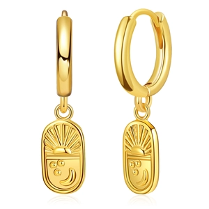 Close-up of 18K gold plated hoop earrings with embossed sun and moon celestial pendants