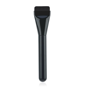 Macro detail of the dense flat-head bristles on a slim black liquid foundation brush