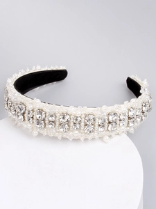 Detailed shot of white pearl and rhinestone headband on a display stand