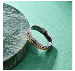 Detailed macro of two-tone stainless steel wedding band with encrusted crystals
