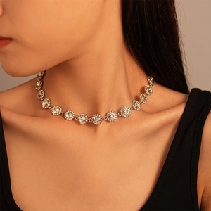 Detail of luxury silver choker featuring sparkling round crystals on female model neck