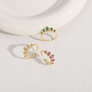 Detailed close-up of three gold adjustable rings featuring marquise-cut colorful zircons
