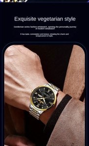 Detail of men's two-tone gold watch with black diamond-set roman numeral dial on wrist