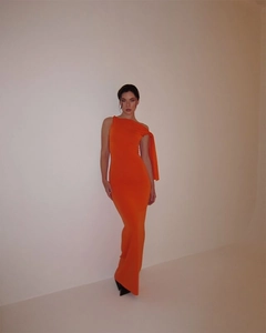 Detail of the elegant orange one-shoulder slim fit maxi dress for summer evening parties