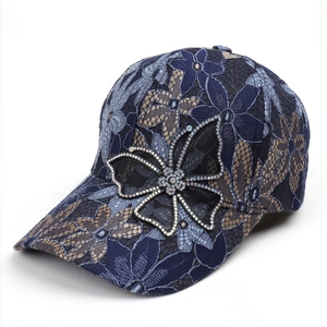 Detail of lace flower texture and rhinestone butterfly decor on sun hat