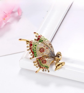 Detail of vintage fairy butterfly brooch with colorful enamel wings and golden finish