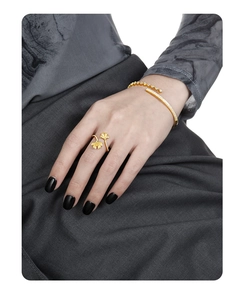 Detail of golden S925 sterling silver ginkgo leaf ring and sparkling paved crystal bangle