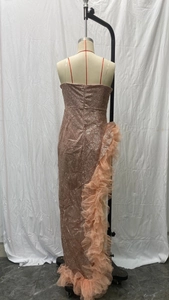 Detail of rose gold sequin evening dress showing the side ruffles and back zipper closure