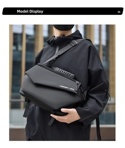 Model wearing a black functional crossbody bag featuring a white Fashion Bag logo print
