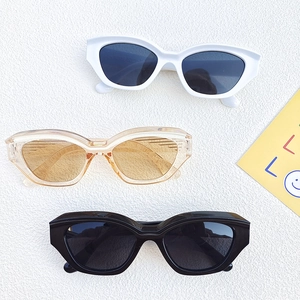 Retro cat eye sunglasses with thick frames in black, white, and translucent tea colors