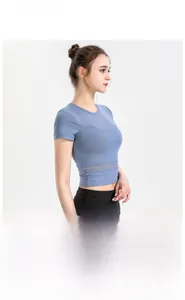 Detail of blue cropped sports top showing breathable mesh panels and slim fit design