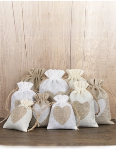 Linen drawstring jewelry pouches with stitched heart patterns in various sizes and colors