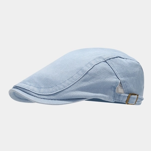Close-up of light blue twill cotton flat cap with vintage metal adjustable buckle detail