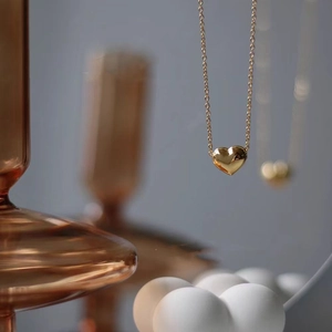 Polished 18K gold heart pendant necklace on delicate chain for elegant daily wear