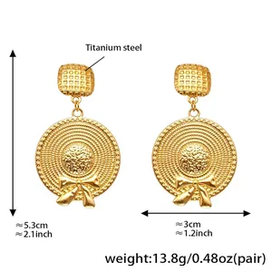Detailed view of titanium steel golden bow earrings with woven texture and dimensions