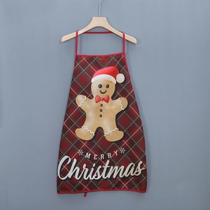 Detail showing gingerbread man print and Merry Christmas text on plaid holiday apron