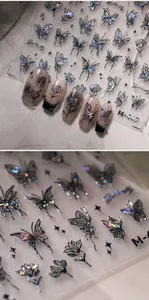 Macro view of holographic butterfly and floral nail art stickers with M-447 laser finish