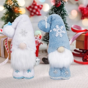 Detail of blue and white Christmas gnomes with snowflake embroidery in festive setting