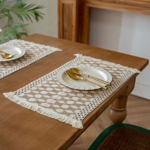Bohemian woven placemat with geometric diamond pattern and handmade tassels in beige