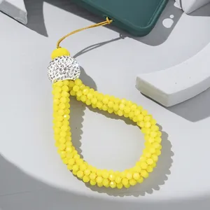 Bright yellow faceted beaded phone wrist strap with sparkling rhinestone metal cap
