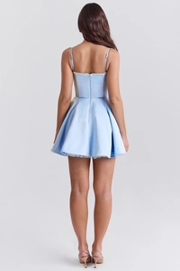Detail view of light blue backless mini dress with silk texture and white lace hem finish