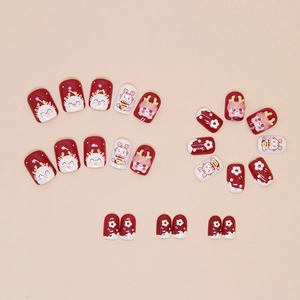 Detail view of burgundy wine red dragon year press-on nails with cute floral patterns