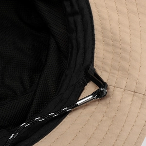 Close-up of khaki waterproof fabric and black mesh lining with reinforced wind rope detail