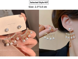 Detail of 925 silver needle pearl tassel earrings with rhinestones in golden finish