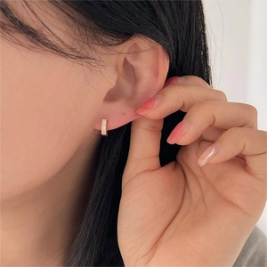 Minimalist 925 sterling silver gold hoop earrings with cubic zirconia row on female ear