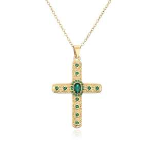Detail of 18K gold plated cross pendant necklace with green zircon stones on white background