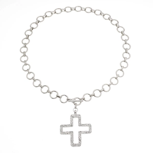 Macro shot of silver metal chain necklace with zircon-inlaid cross pendant and T-bar toggle