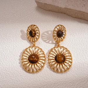 Vintage gold hollow-out fan earrings with tiger eye stone in a professional macro shot